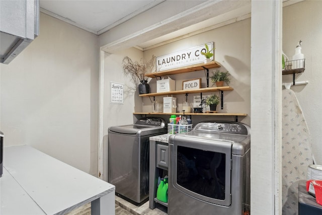 washroom featuring separate washer and dryer, laundry area, and ornamental molding