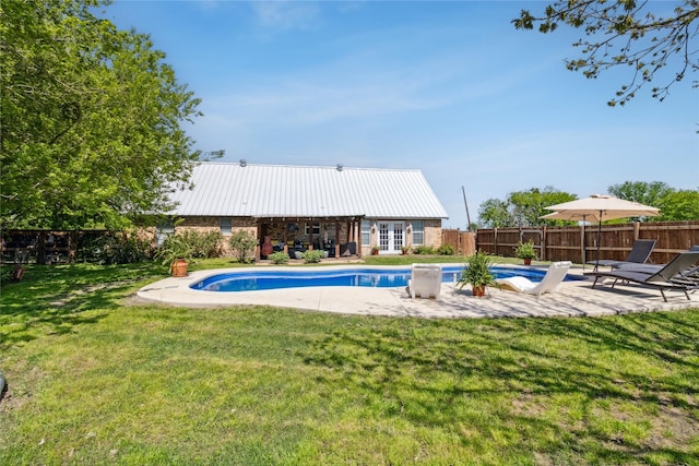 view of pool featuring a fenced in pool, fence private yard, a patio, and a lawn
