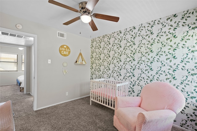 1905 W Morton St Unit 5, Denison, TX 75020 - bedroom featuring carpet flooring, baseboards, ceiling fan, wallpapered walls, and a crib