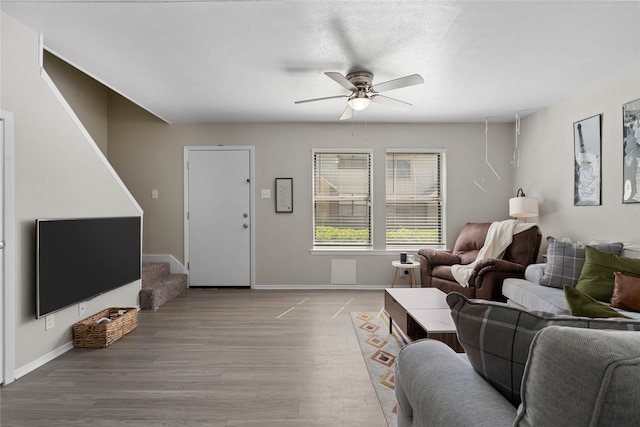 1905 W Morton St Unit 5, Denison, TX 75020 - living room with stairs, ceiling fan, light wood-style floors, and baseboards