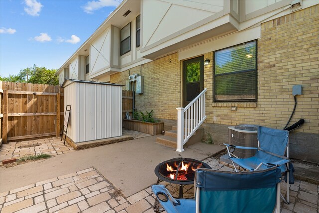 1905 W Morton St Unit 5, Denison, TX 75020 - view of patio with an outdoor fire pit, a storage shed, entry steps, fence, and an outdoor structure