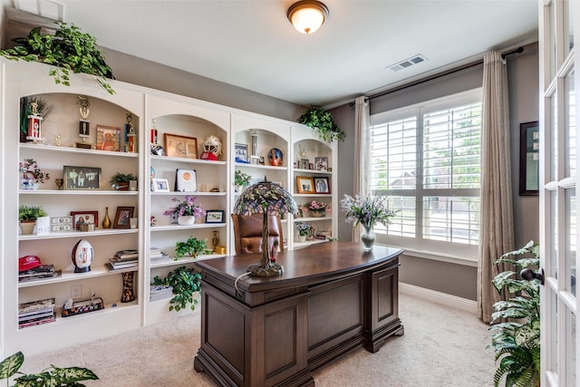 home office featuring light carpet, visible vents, and a wealth of natural light