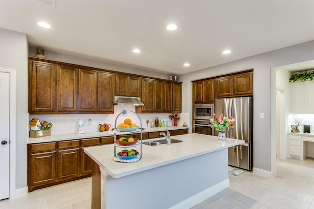 kitchen featuring a sink, tasteful backsplash, recessed lighting, under cabinet range hood, and appliances with stainless steel finishes