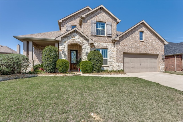view of front of home featuring a front lawn, driveway, stone siding, brick siding, and a garage