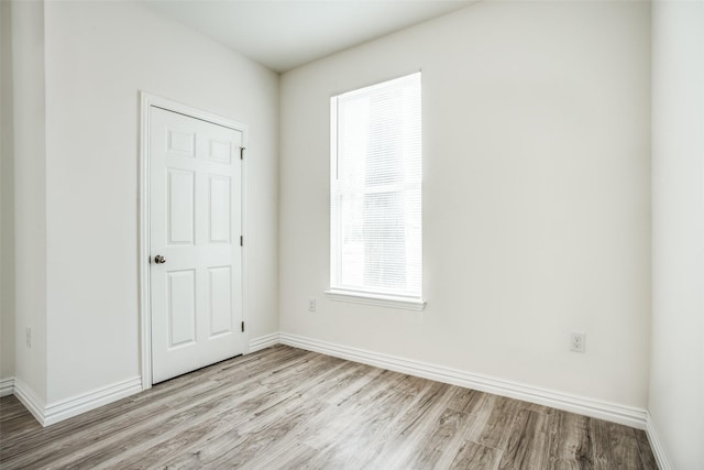unfurnished bedroom with baseboards and light wood finished floors
