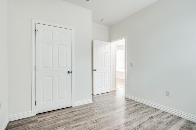 unfurnished bedroom with baseboards and wood finished floors