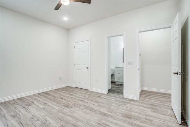 unfurnished bedroom featuring baseboards, recessed lighting, a ceiling fan, light wood-type flooring, and ensuite bath