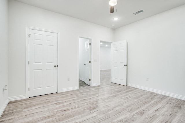 unfurnished bedroom with baseboards, ceiling fan, visible vents, and light wood finished floors