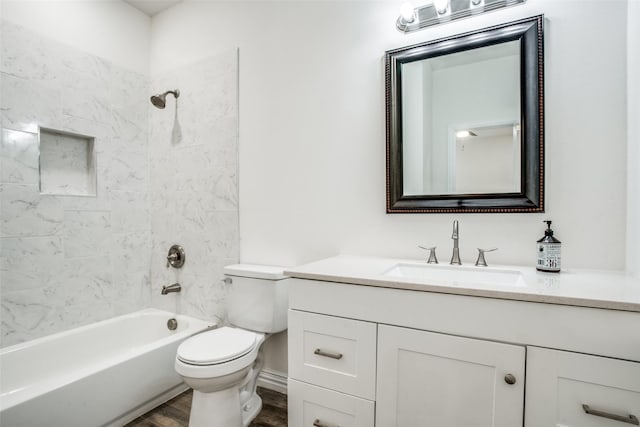 full bathroom featuring tub / shower combination, wood finished floors, toilet, and vanity