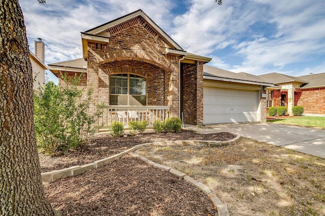 ranch-style home with a porch, a garage, brick siding, and concrete driveway