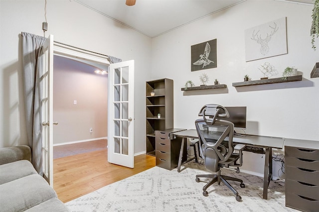 office space with baseboards, wood finished floors, and french doors