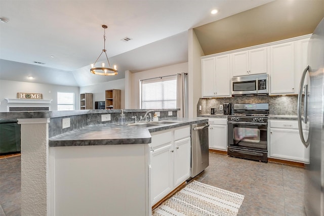 kitchen featuring a kitchen island with sink, dark countertops, tasteful backsplash, appliances with stainless steel finishes, and a sink