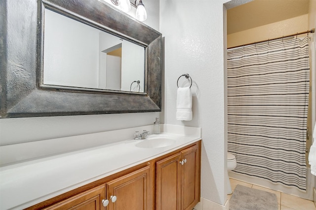 full bath featuring tile patterned flooring, vanity, toilet, a textured wall, and a shower with shower curtain
