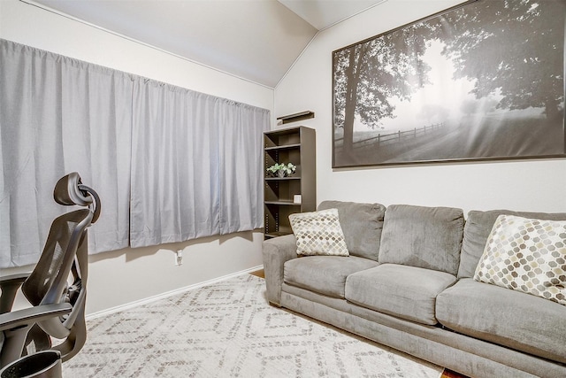 living room featuring baseboards and lofted ceiling