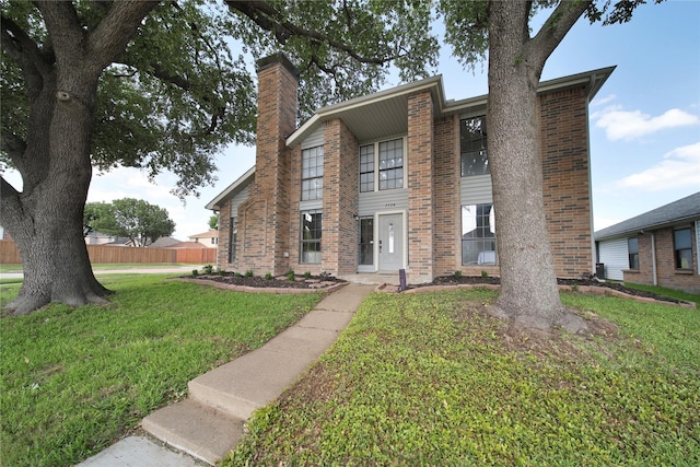 7724 Standish Cir, Plano, TX 75025 - view of front of home with a chimney, a front yard, and brick siding