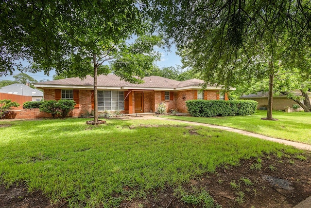 2306 Ravenwood Dr, Grand Prairie, TX 75050 - ranch-style house with a front yard and brick siding