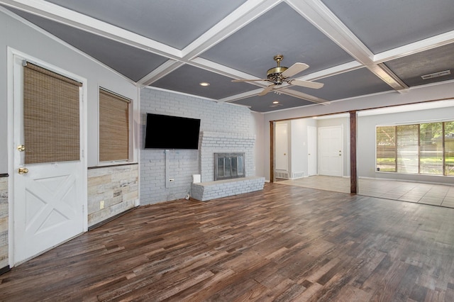2306 Ravenwood Dr, Grand Prairie, TX 75050 - unfurnished living room featuring coffered ceiling, wood finished floors, a ceiling fan, beam ceiling, and a fireplace