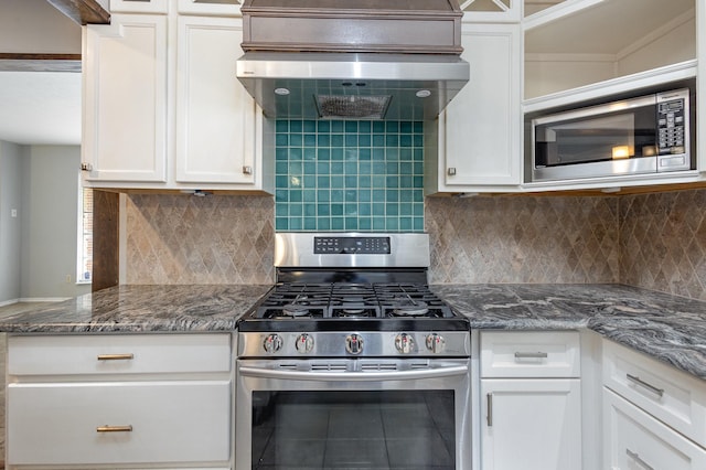 2306 Ravenwood Dr, Grand Prairie, TX 75050 - kitchen featuring appliances with stainless steel finishes, white cabinetry, glass insert cabinets, and backsplash