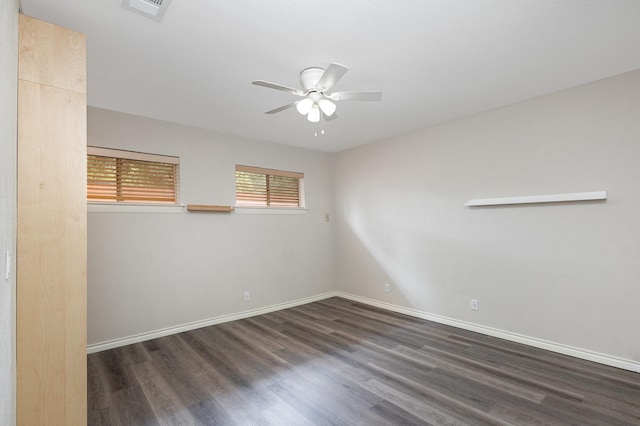 2306 Ravenwood Dr, Grand Prairie, TX 75050 - empty room featuring a ceiling fan, dark wood-type flooring, and baseboards
