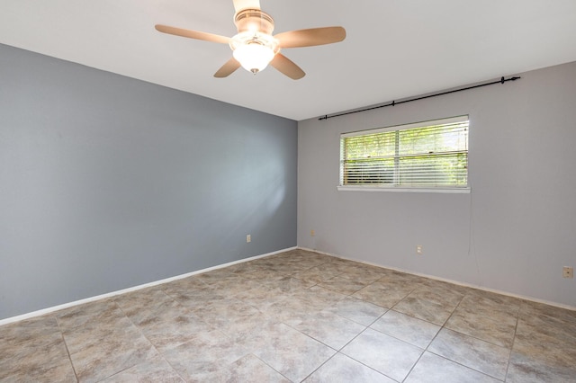 2306 Ravenwood Dr, Grand Prairie, TX 75050 - unfurnished room with a ceiling fan, light tile patterned floors, and baseboards