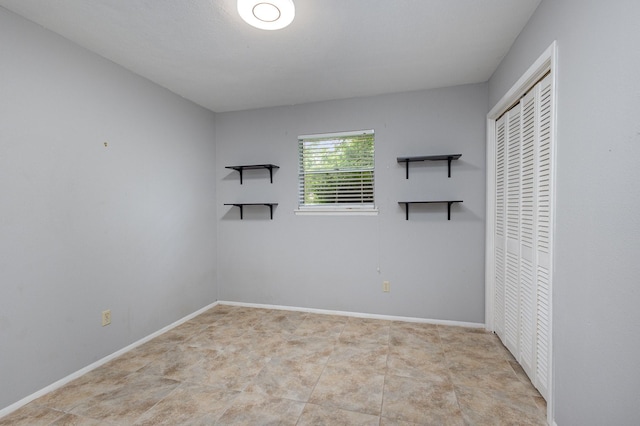 2306 Ravenwood Dr, Grand Prairie, TX 75050 - unfurnished bedroom with a closet and baseboards