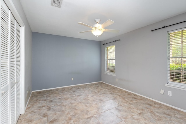 2306 Ravenwood Dr, Grand Prairie, TX 75050 - spare room featuring healthy amount of natural light, a ceiling fan, and baseboards