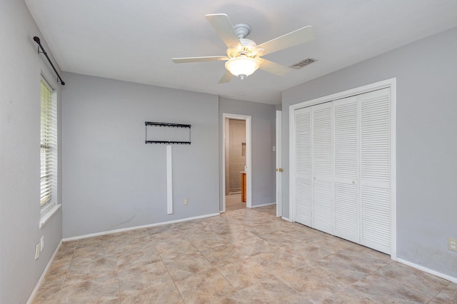 2306 Ravenwood Dr, Grand Prairie, TX 75050 - unfurnished bedroom with a closet, a ceiling fan, baseboards, and ensuite bath