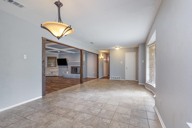 2306 Ravenwood Dr, Grand Prairie, TX 75050 - spare room with a brick fireplace and baseboards