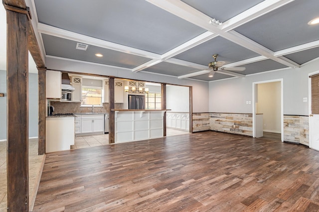 2306 Ravenwood Dr, Grand Prairie, TX 75050 - unfurnished living room with wood finished floors, coffered ceiling, ceiling fan, a chandelier, and beam ceiling