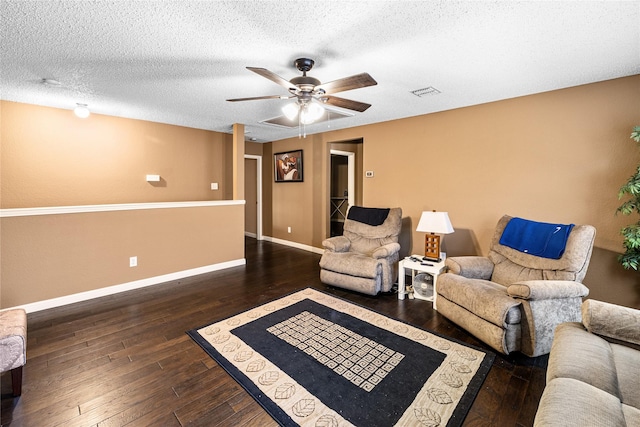 living area with a textured ceiling, baseboards, visible vents, a ceiling fan, and wood-type flooring