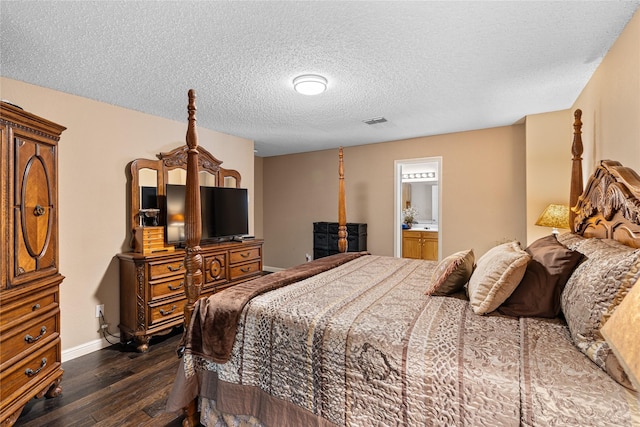 bedroom with dark wood-style floors, a textured ceiling, connected bathroom, baseboards, and visible vents