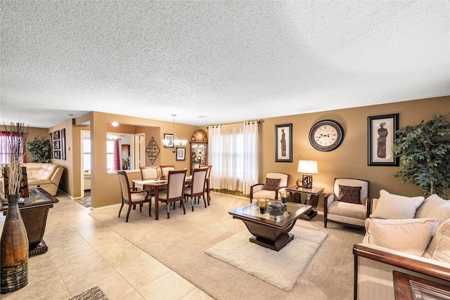 living room with a textured ceiling and light tile patterned floors