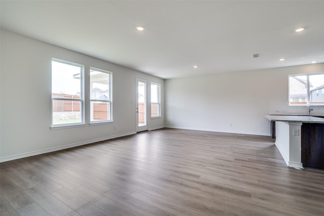 3800 Parsons St, Crandall, TX 75114 - unfurnished living room with plenty of natural light, recessed lighting, and wood finished floors
