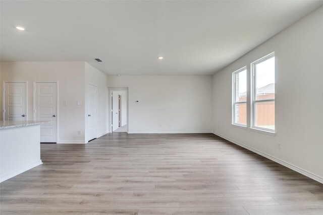 3800 Parsons St, Crandall, TX 75114 - unfurnished living room with recessed lighting, baseboards, visible vents, and light wood-style flooring