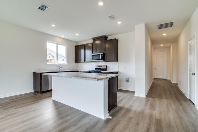 3800 Parsons St, Crandall, TX 75114 - kitchen with visible vents, light wood finished floors, a kitchen island, and stainless steel appliances