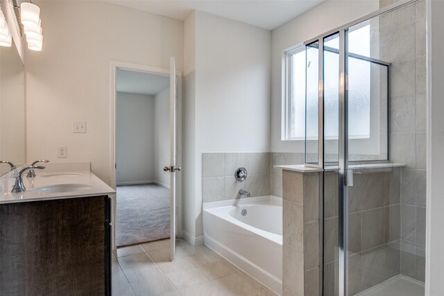 3836 Parsons St, Crandall, TX 75114 - bathroom with double vanity, a garden tub, a stall shower, a sink, and tile patterned floors