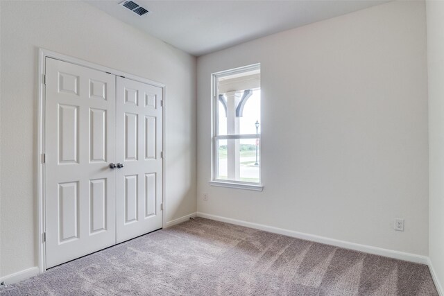 3836 Parsons St, Crandall, TX 75114 - unfurnished bedroom with visible vents, baseboards, a closet, and light colored carpet