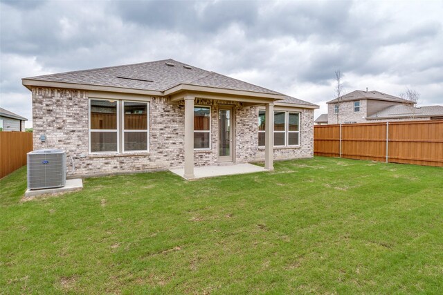 3836 Parsons St, Crandall, TX 75114 - rear view of house with cooling unit, a fenced backyard, brick siding, a patio area, and a yard