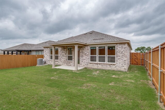 3836 Parsons St, Crandall, TX 75114 - rear view of house with cooling unit, a patio, a fenced backyard, brick siding, and a shingled roof