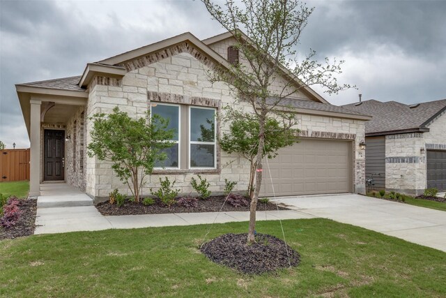 3836 Parsons St, Crandall, TX 75114 - view of front of property featuring driveway, a front yard, a garage, a shingled roof, and stone siding