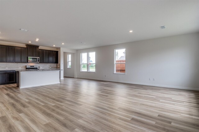 3836 Parsons St, Crandall, TX 75114 - unfurnished living room with light wood-type flooring, recessed lighting, and baseboards