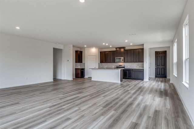 3836 Parsons St, Crandall, TX 75114 - unfurnished living room featuring recessed lighting, baseboards, and light wood-type flooring