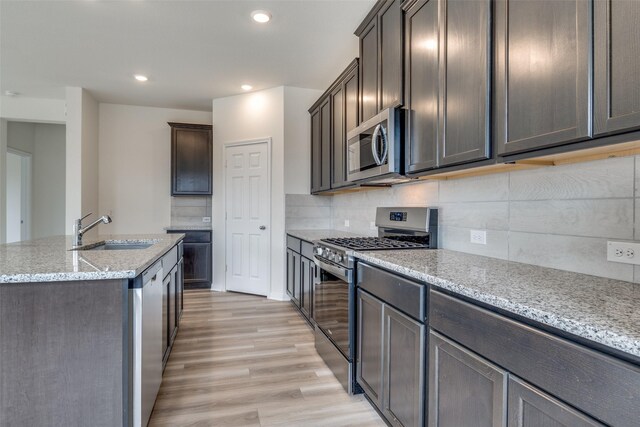3836 Parsons St, Crandall, TX 75114 - kitchen featuring recessed lighting, light stone countertops, appliances with stainless steel finishes, and a sink