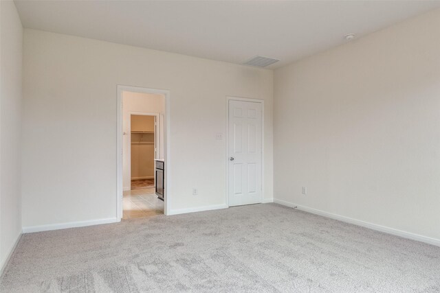 3836 Parsons St, Crandall, TX 75114 - unfurnished bedroom featuring baseboards, light colored carpet, a spacious closet, and visible vents
