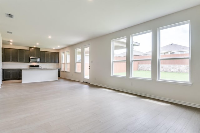 3808 Parsons St, Crandall, TX 75114 - unfurnished living room with visible vents, recessed lighting, light wood finished floors, and baseboards