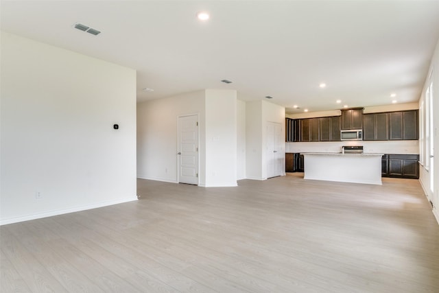 3808 Parsons St, Crandall, TX 75114 - unfurnished living room featuring visible vents, recessed lighting, light wood-style flooring, and baseboards