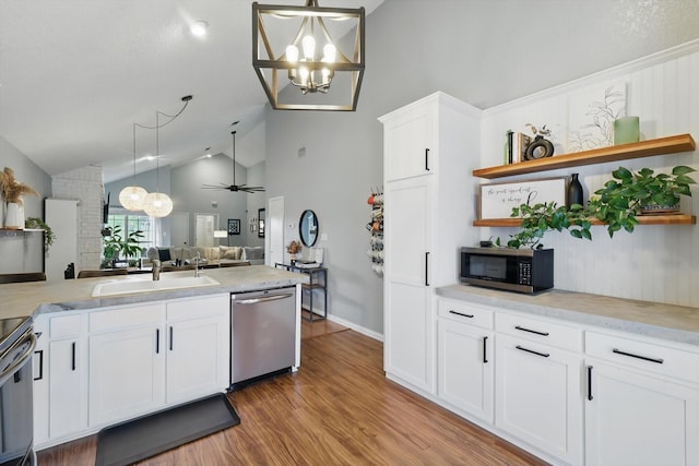 kitchen featuring open floor plan, open shelves, light wood-style floors, stainless steel appliances, and a sink