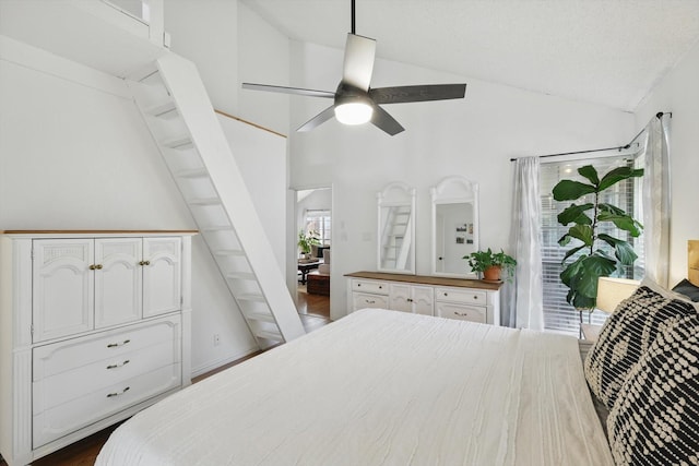 bedroom with high vaulted ceiling, dark wood-style floors, and ceiling fan