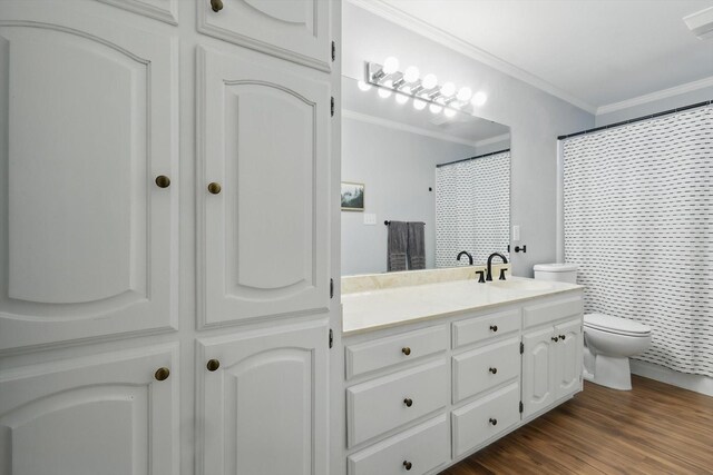 bathroom featuring crown molding, vanity, toilet, curtained shower, and wood finished floors