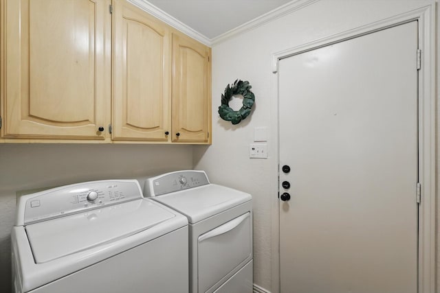 laundry area with washing machine and clothes dryer, ornamental molding, and cabinet space